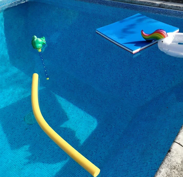 Pool floats and noodle drifting in a clean pool