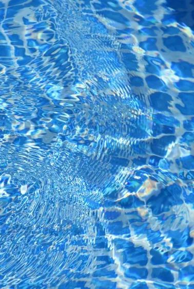 Blue mosaic tile seen through rippling water