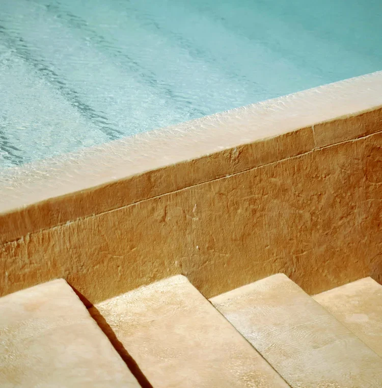 Stone steps leading into clear pool water in Templeton