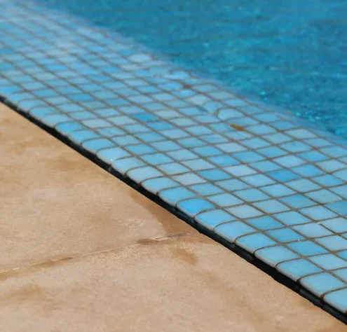 Blue waterline tile and travertine coping