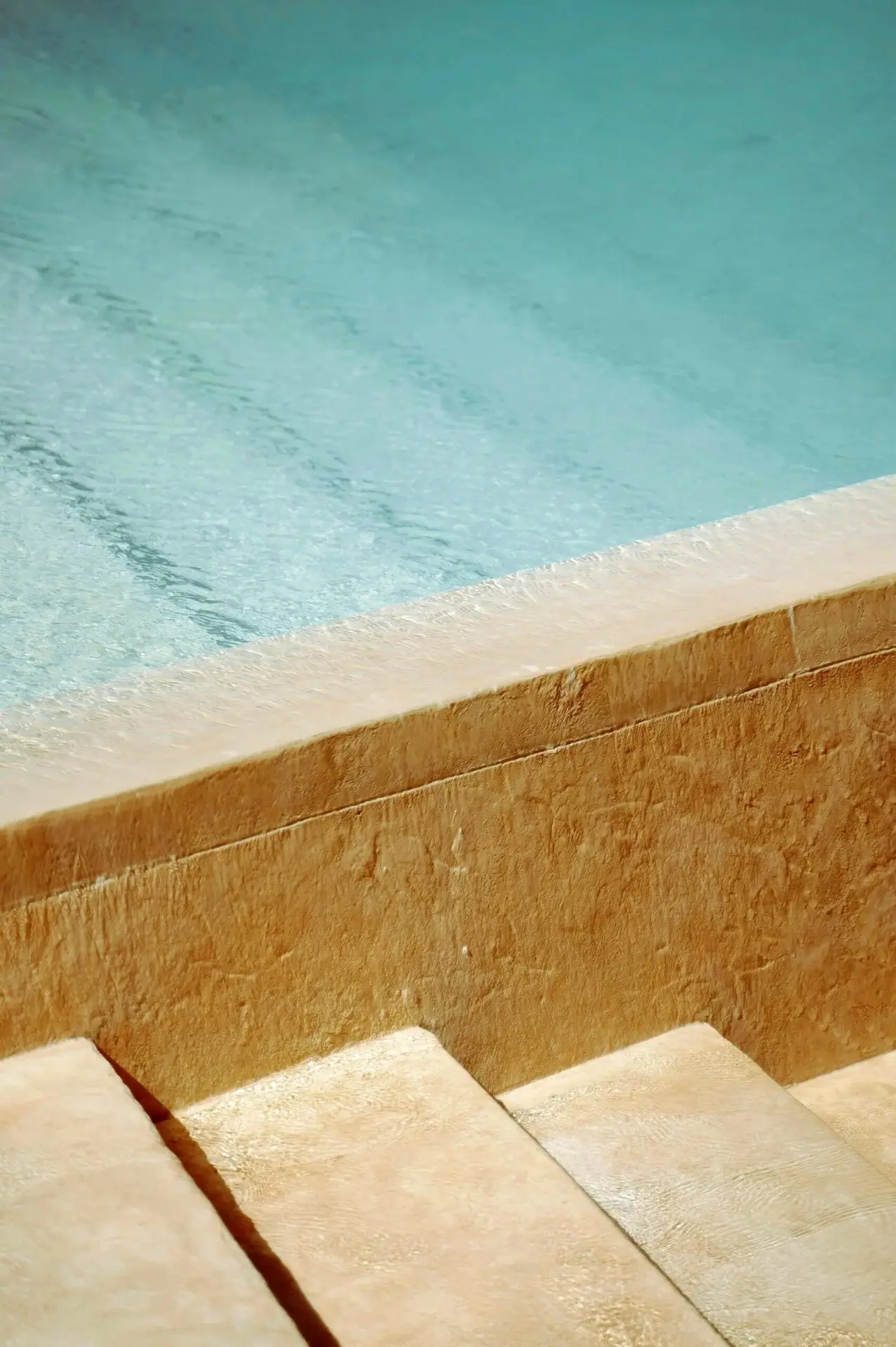 Stone pool steps leading into clear water