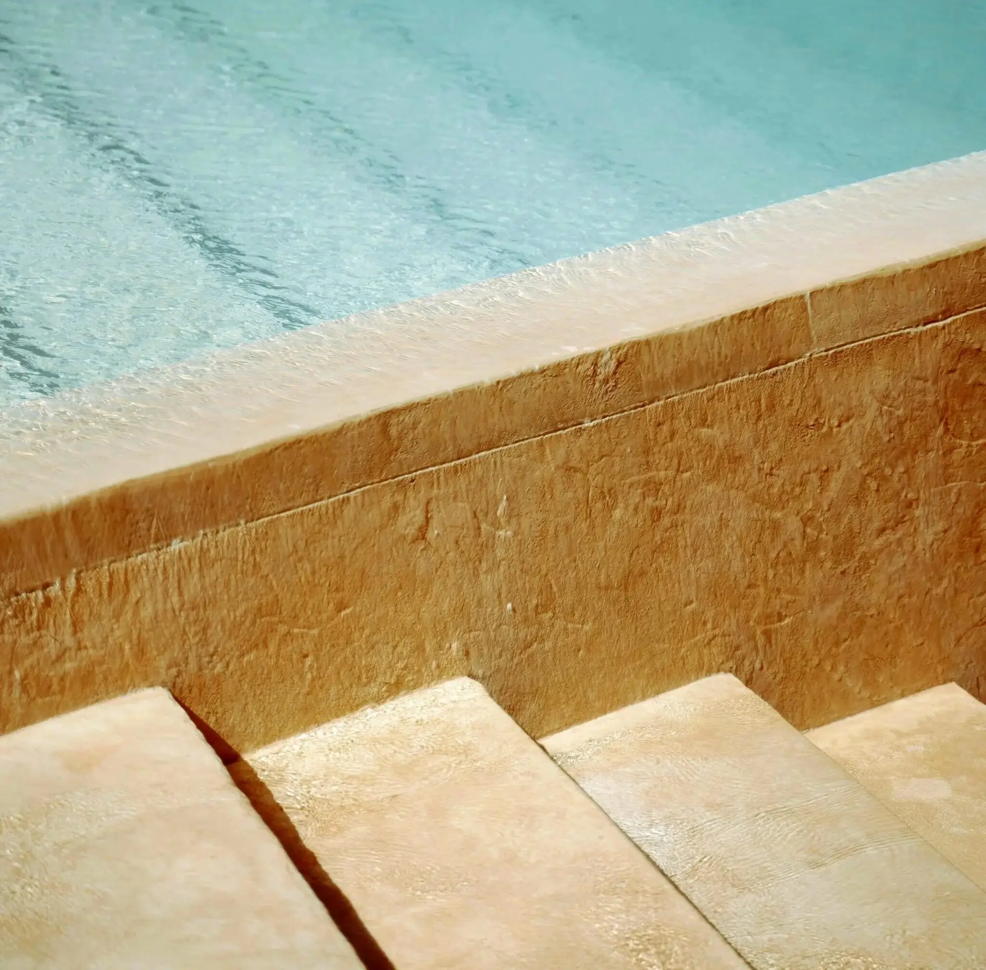 Stone steps leading into a clear pool