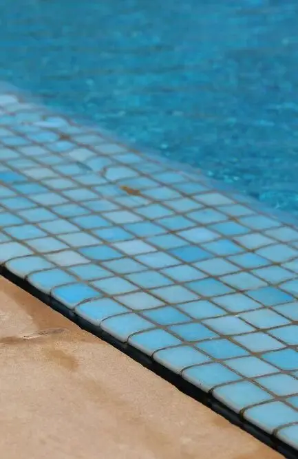 Blue mosaic waterline tile on a clean pool