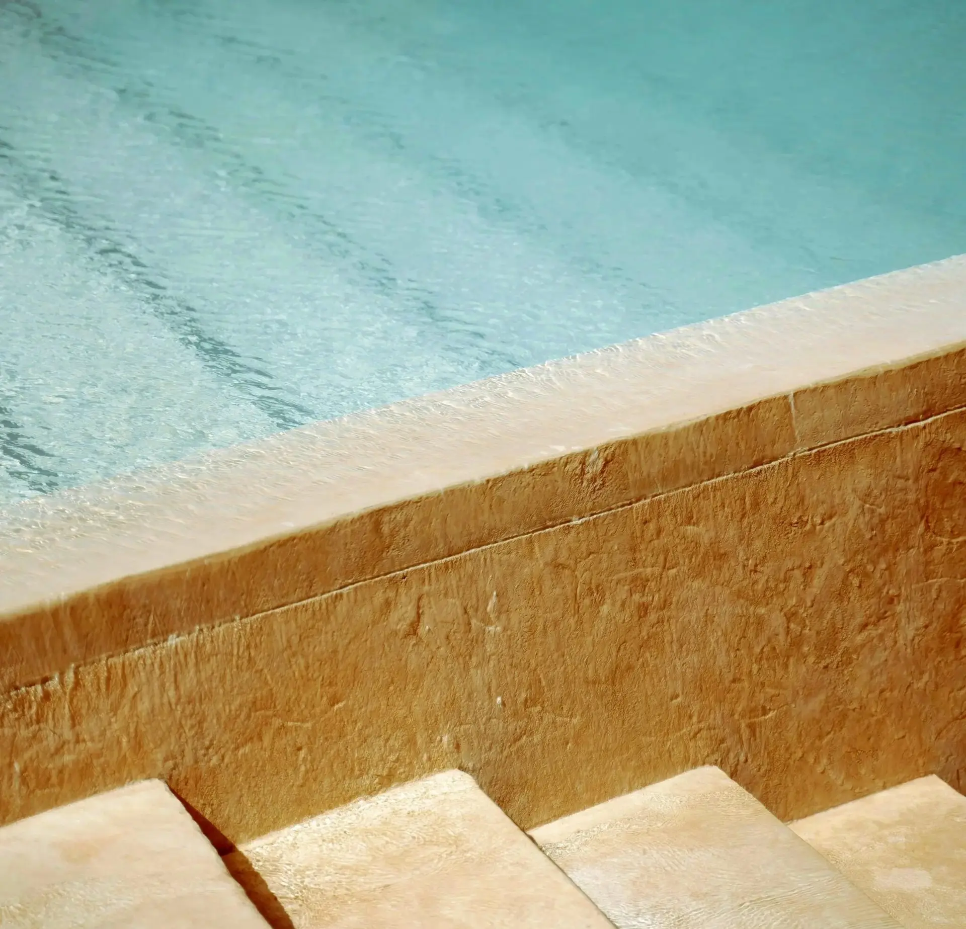 Stone pool steps in clear water