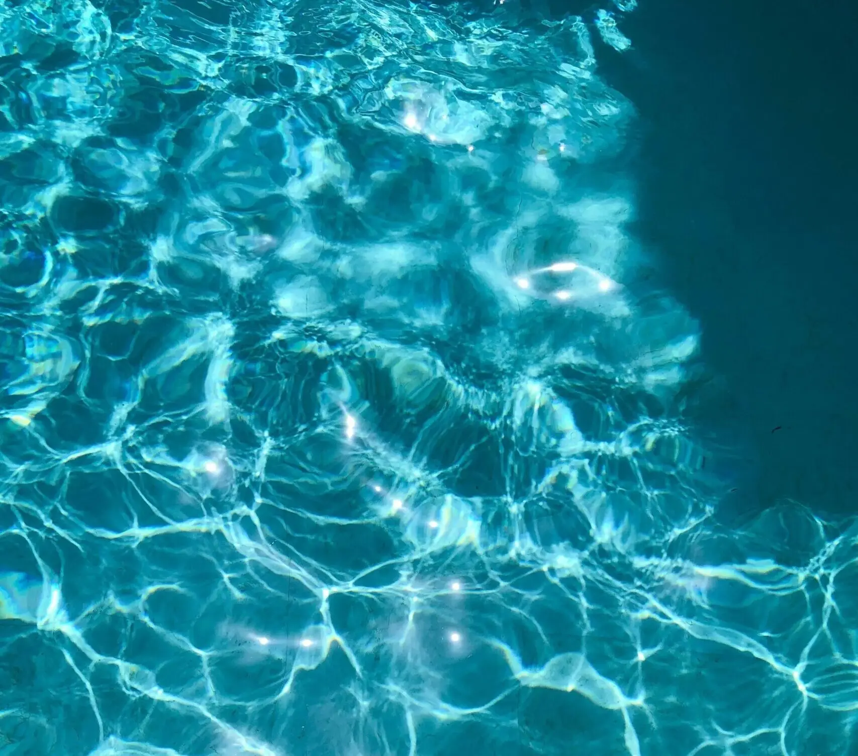 Sunlight reflecting on sparkling pool water