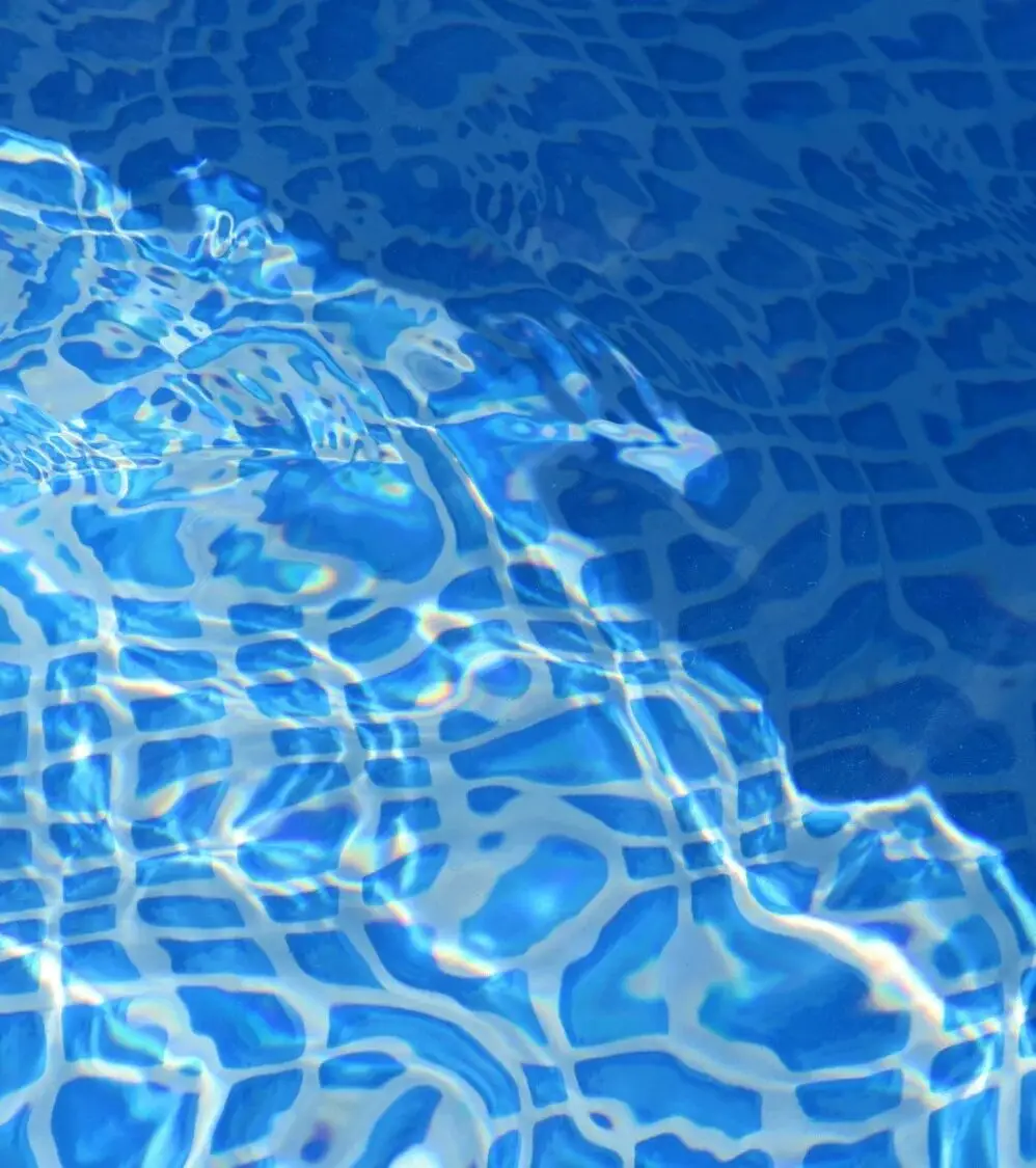 Rippling water over blue pool tile