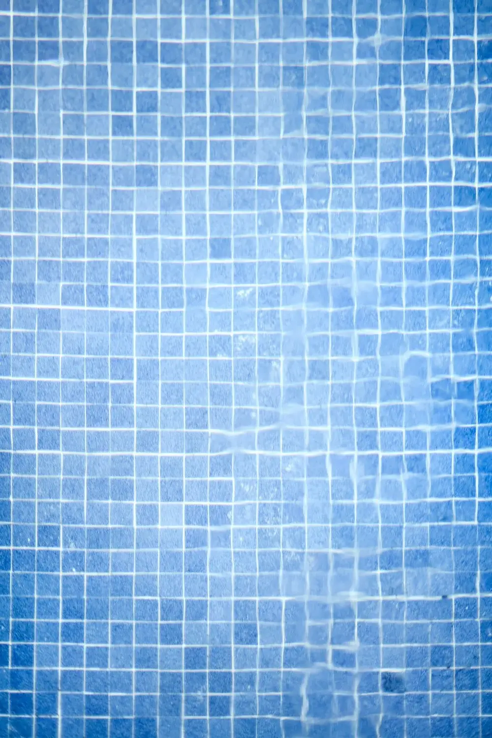 Blue mosaic tile at the pool waterline