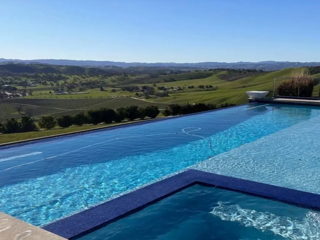 Pool and spa overlooking vineyard hills
