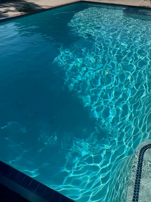 Clear blue backyard pool after professional cleaning